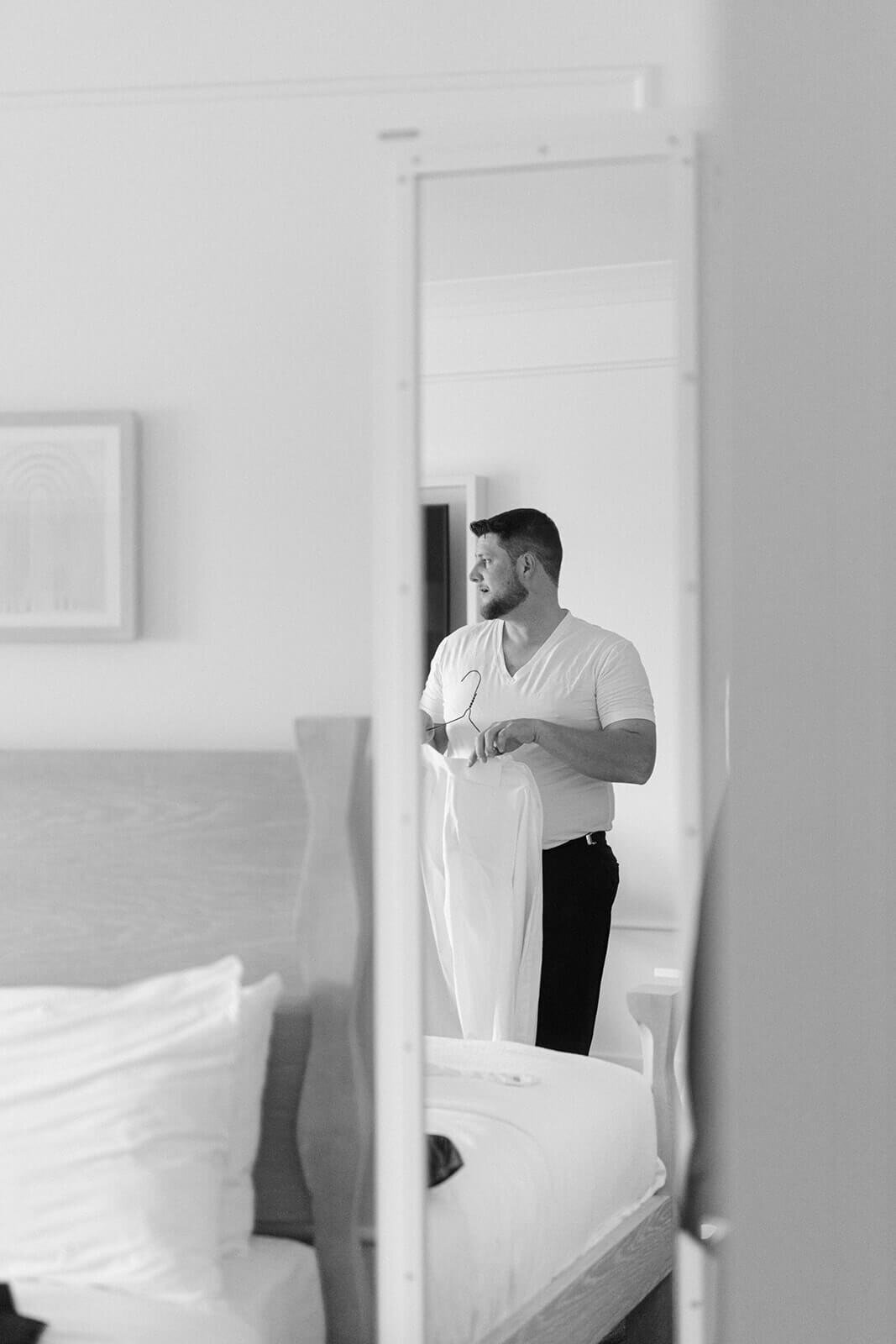 Groom holding shirt