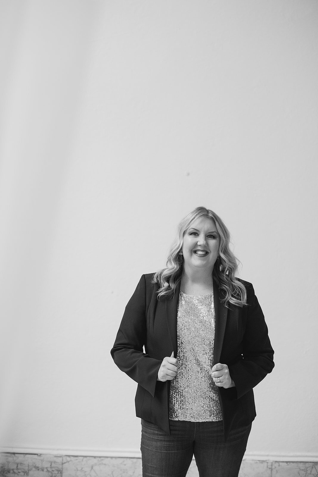Melissa Lawrence smiles in sparkly blouse and black blazer