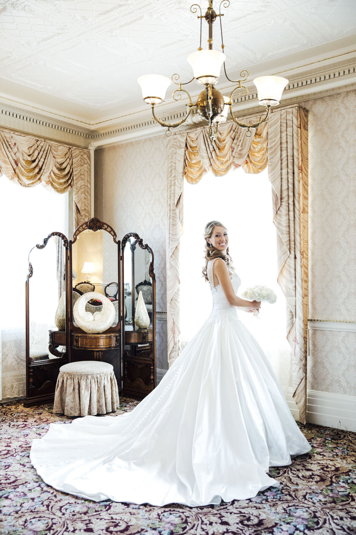 shadowbrook-at-shrewsbury-bride-posing-by-window-in-wedding-dress-shrewsbury-new-jersey