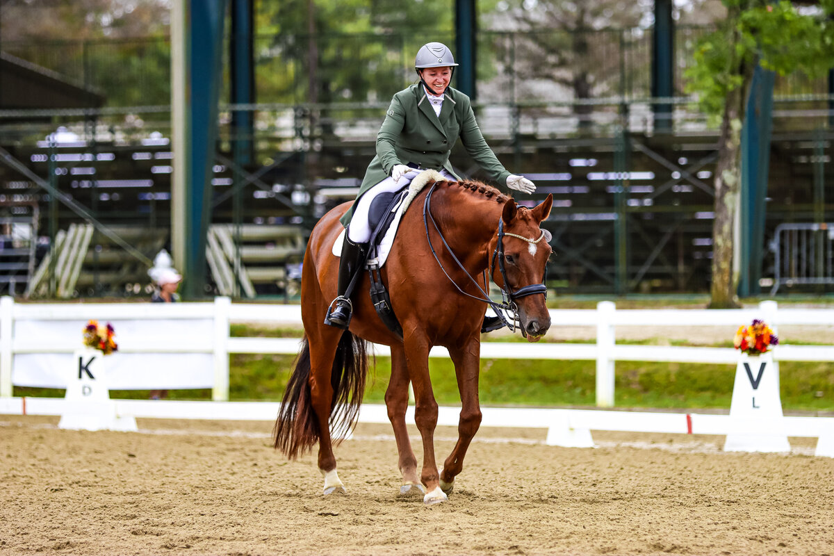 A chestnut horse being patted by its smiling rider at GIHP in Georgia.