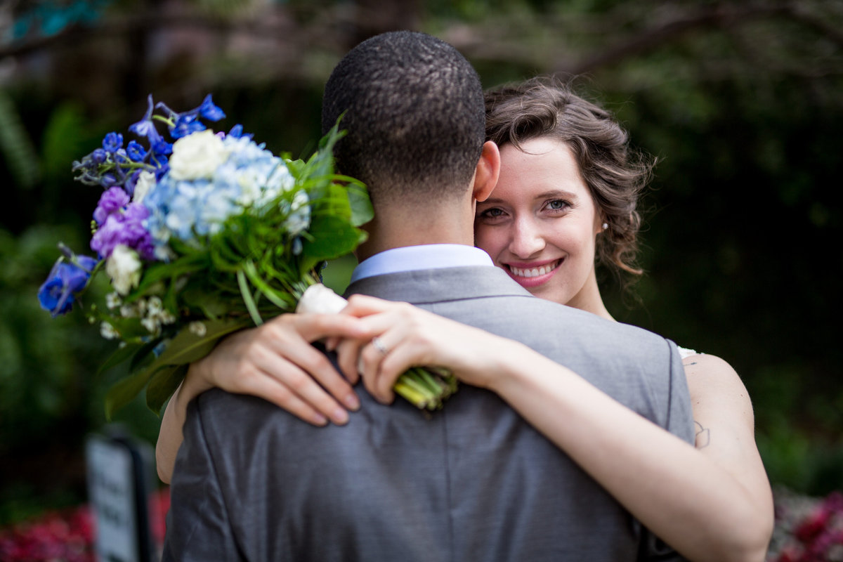 bride looking over grooms shoulder