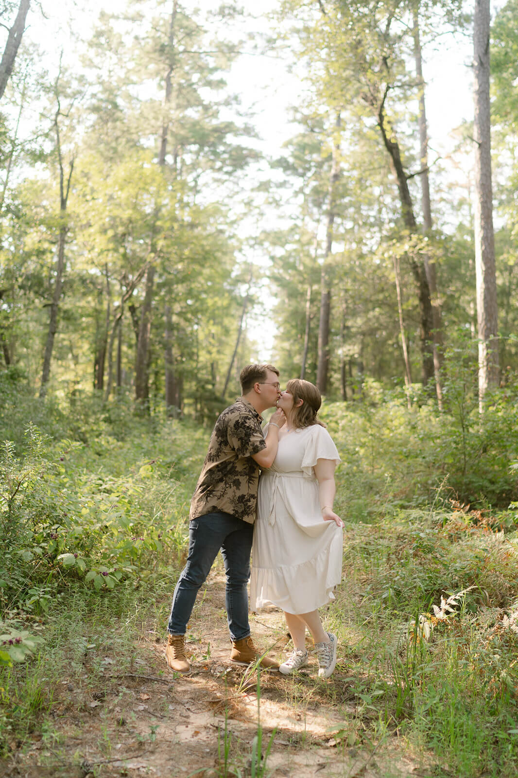 couple kissing in the pine tress