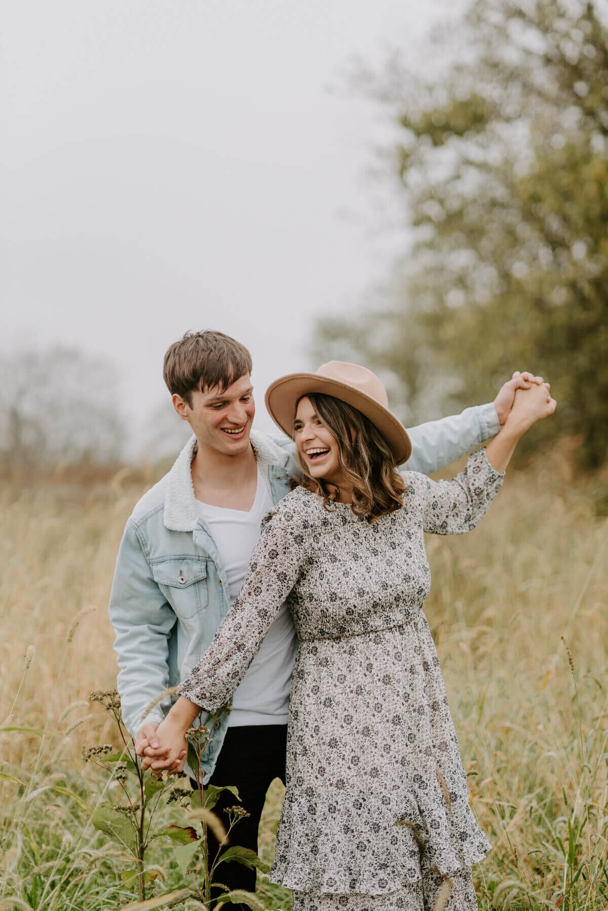 couple with arms stretched taken by engagement photographers in nashville tn