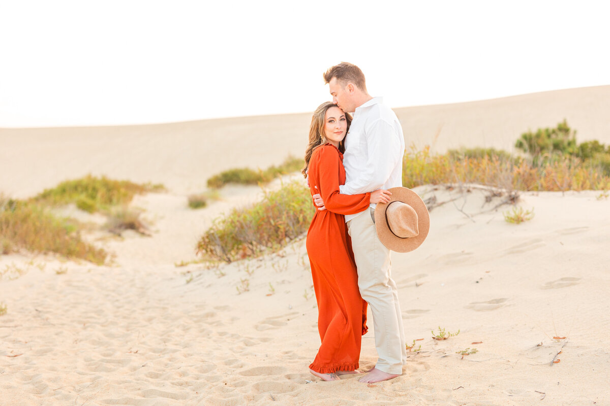 Sandy beach engagement session during sunset in Virginia
