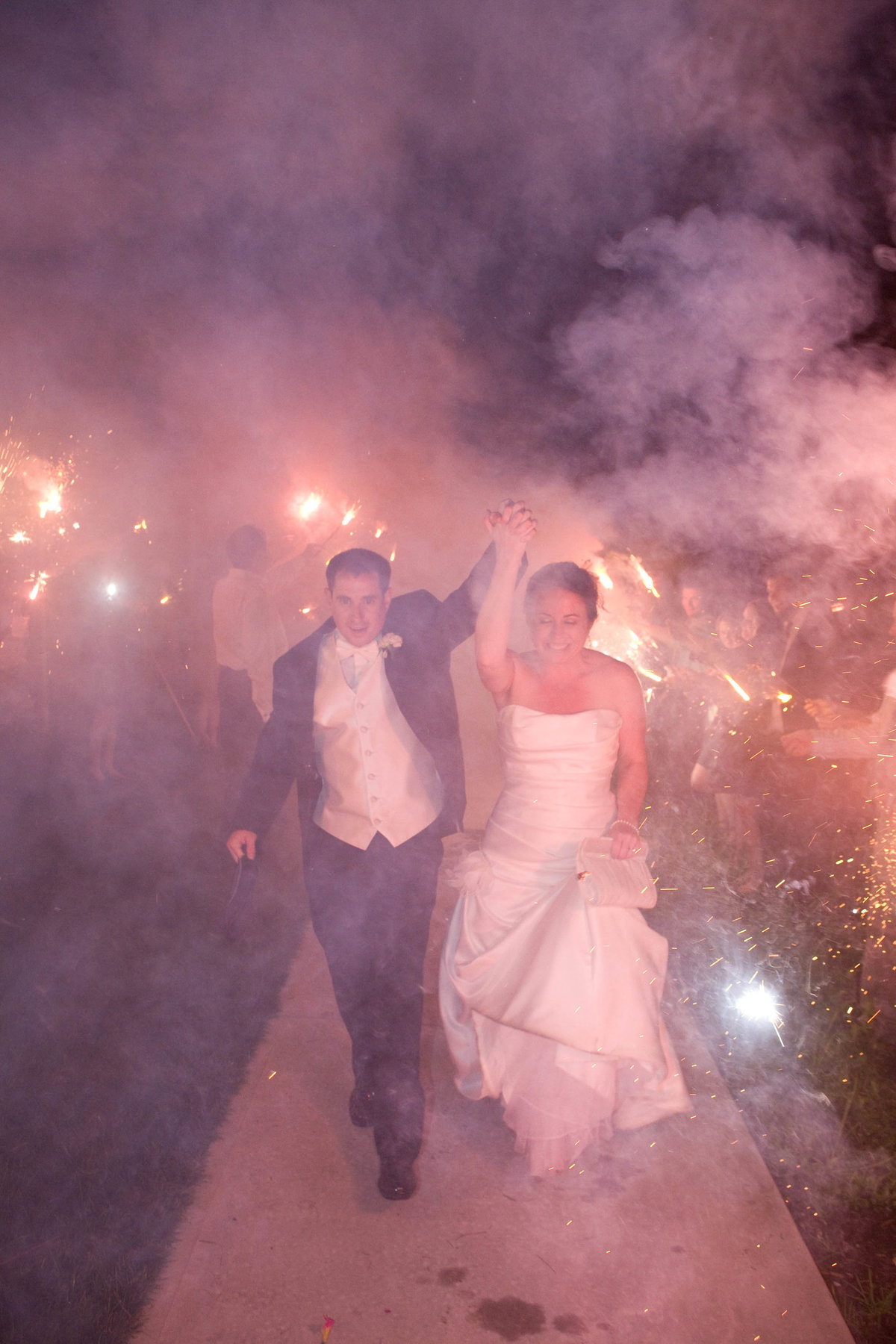 bride and groom  walking out of sparklers sendoff