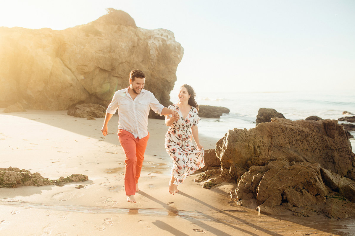 Engagement Photograph Of  Man And Woman Walking On The Shore Los Angeles