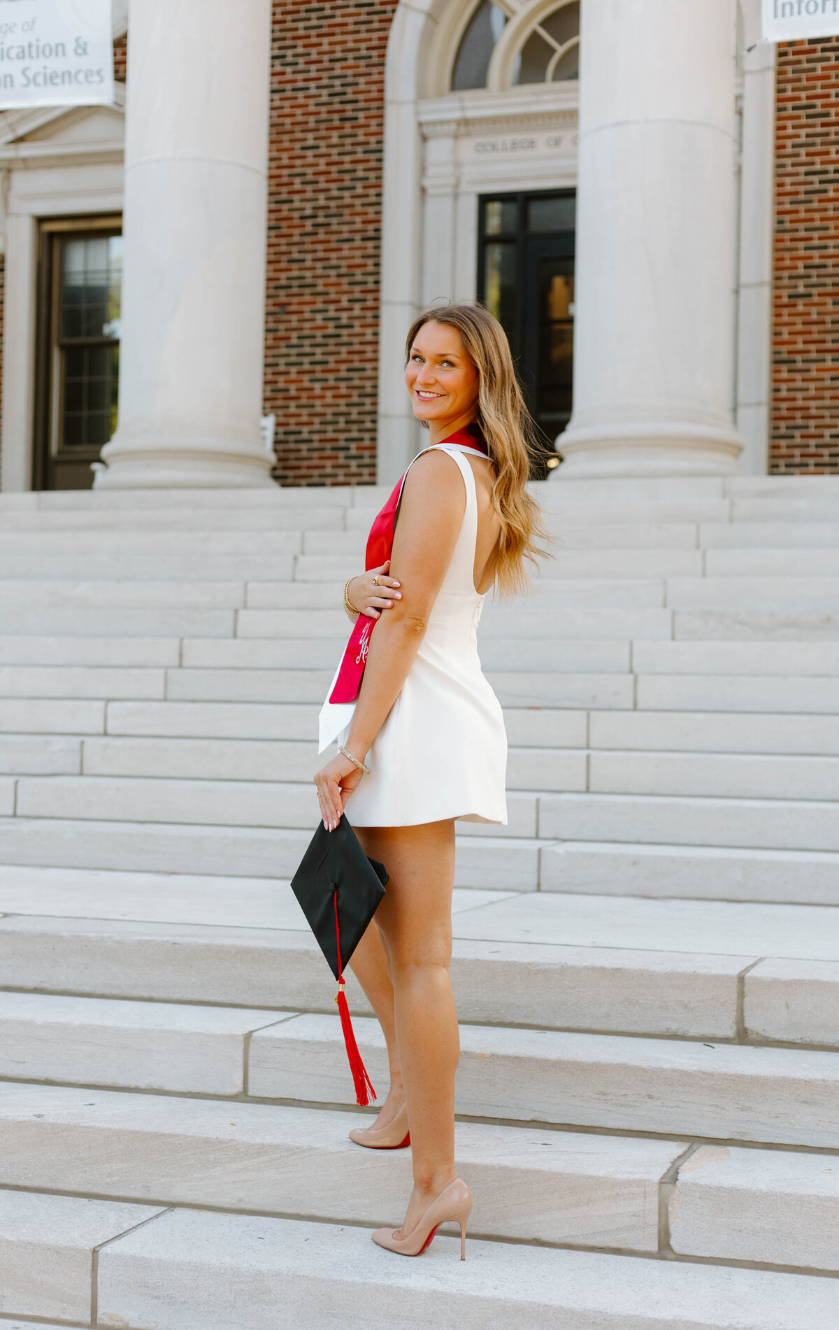 University of Alabama graduate walking up the stairs to Reese Phifer