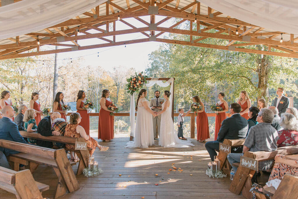 two brides getting married at outdoor covered pavillion at Koury Farms