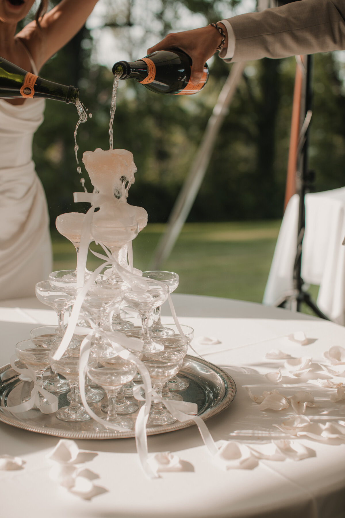 bride and groom pouring champagne