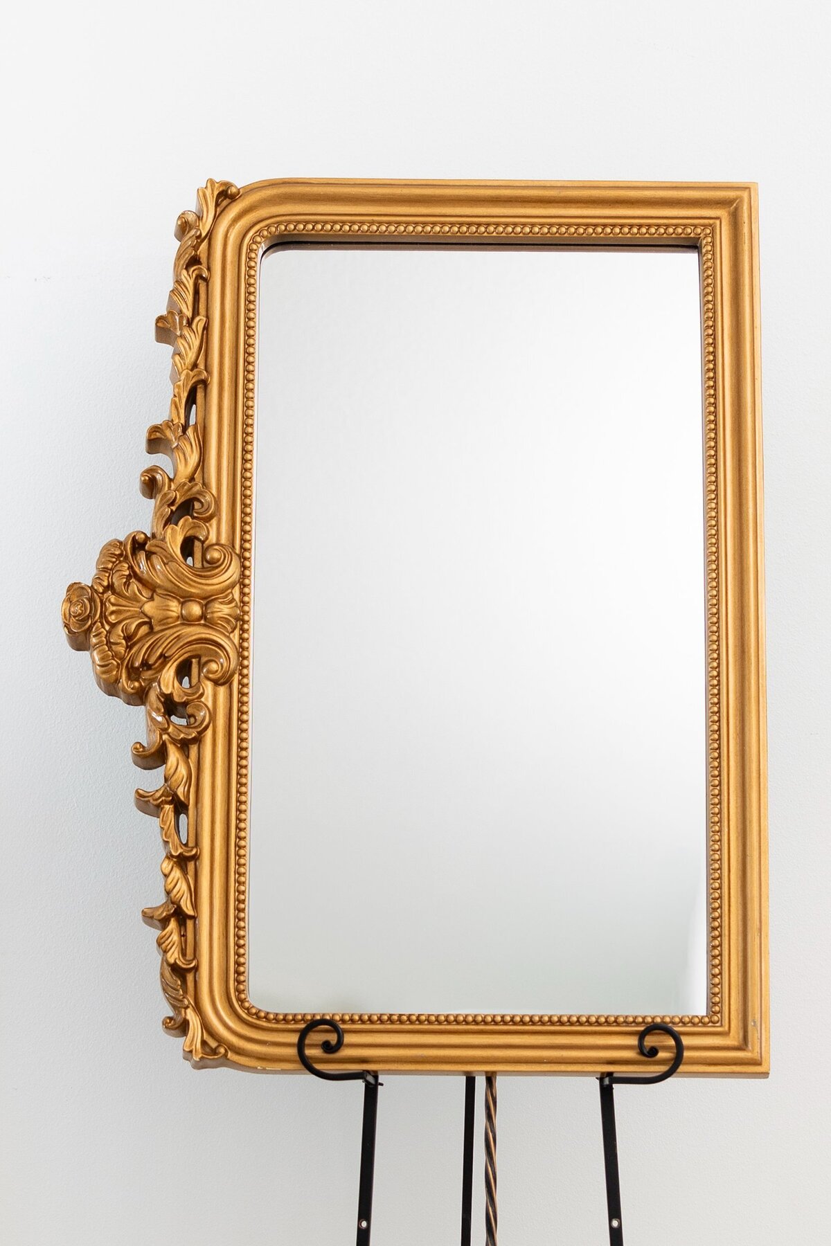 Medium vertical mirror with ornate ornament on top 
