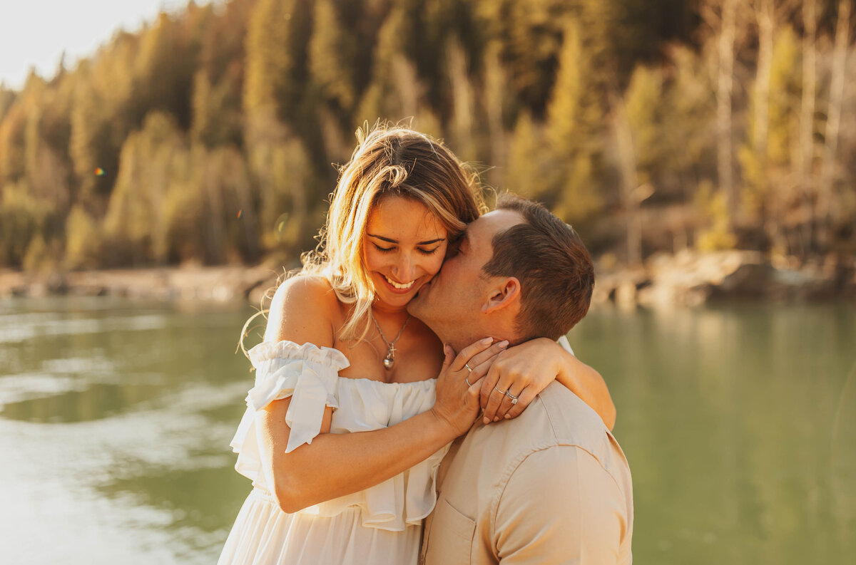 couple kissing by lake