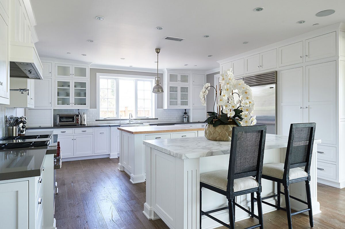 Bright white kitchen with double island