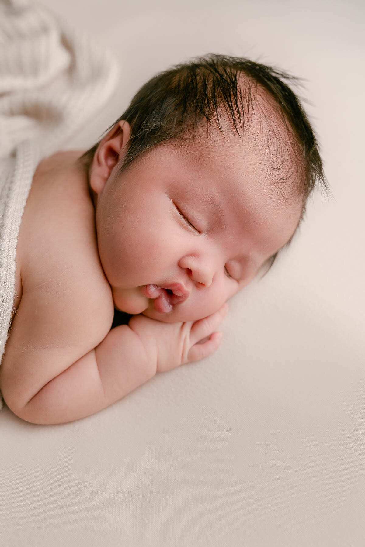 brown haired baby sleeping on stomach by Oregon Newborn Photographer