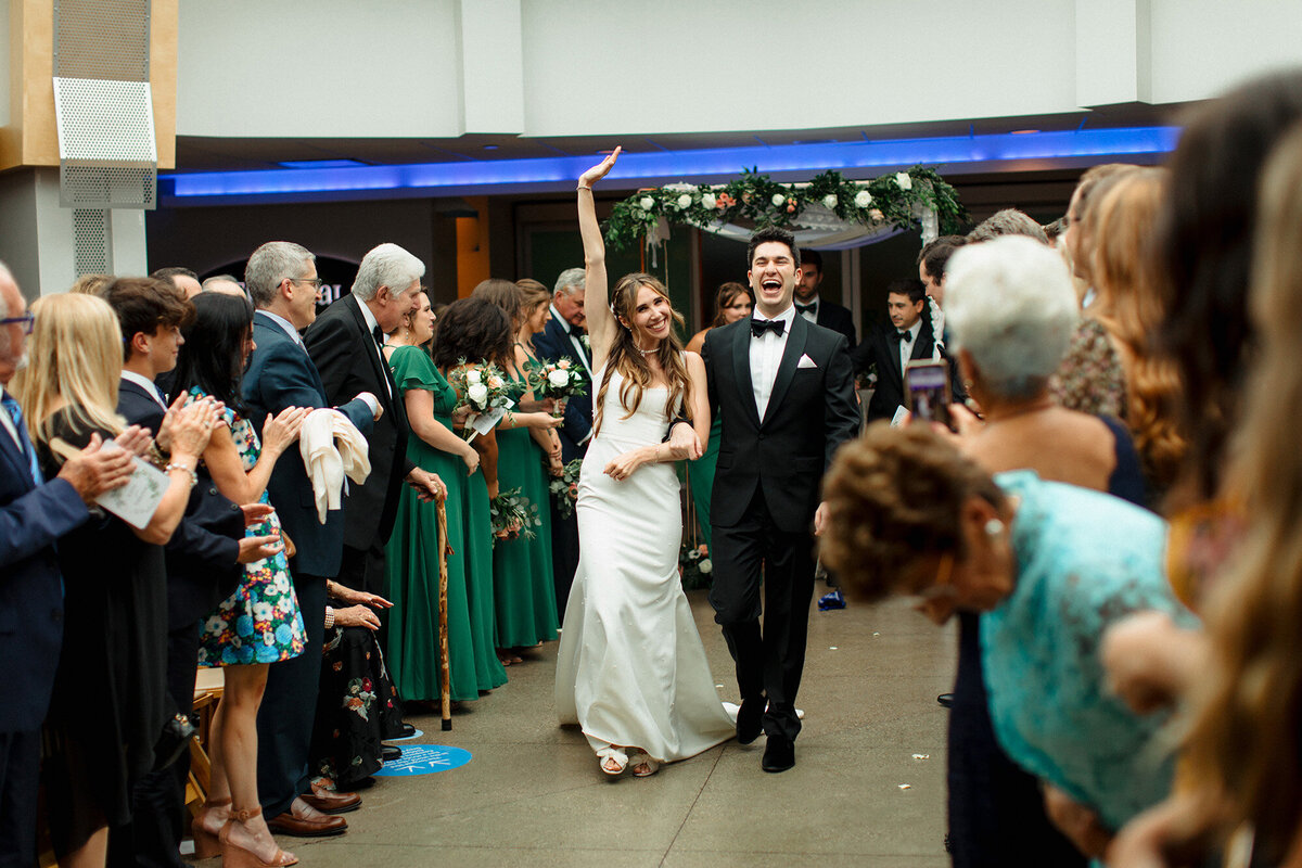 bride-celebrating-with-groom-walking-out-of-ceremony