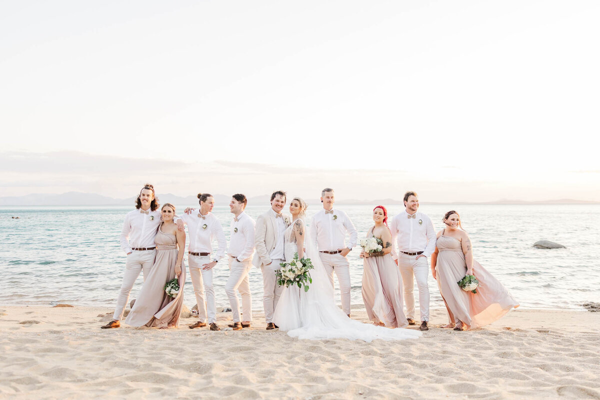 bridal party stand on whitsundays beach during portaits