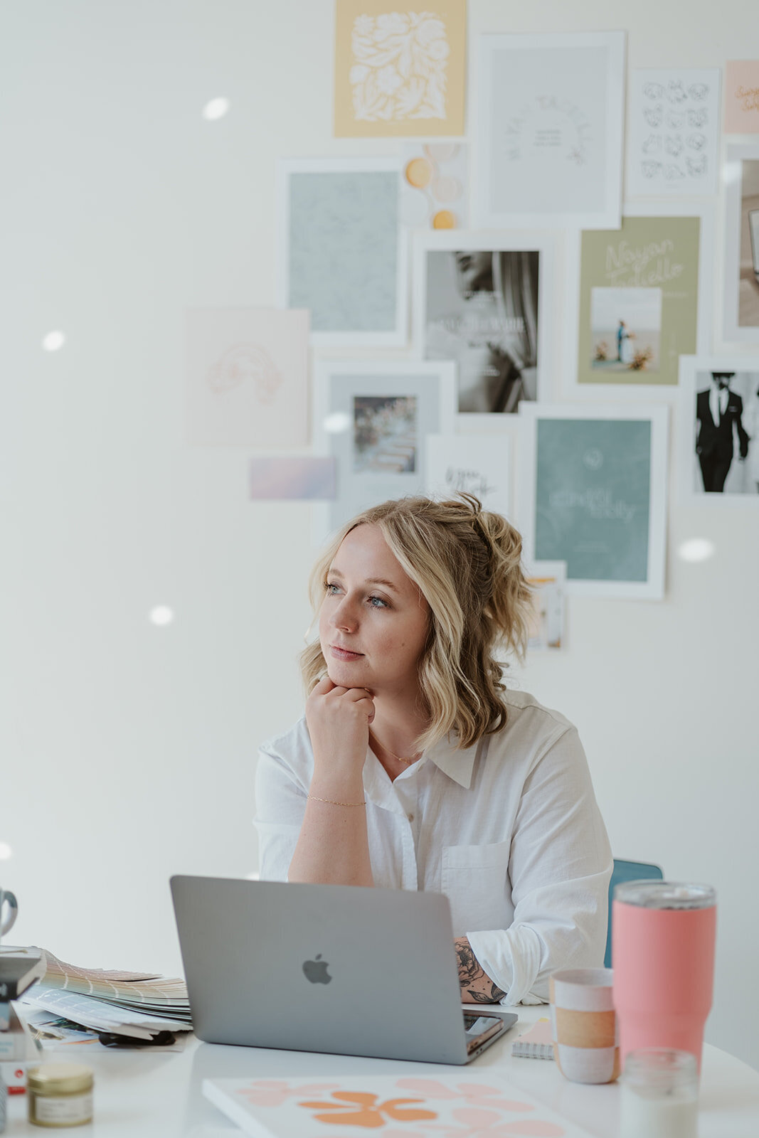 Photo of a woman working at a laptop at a round table during a Wildher and Co creative studio branding session.