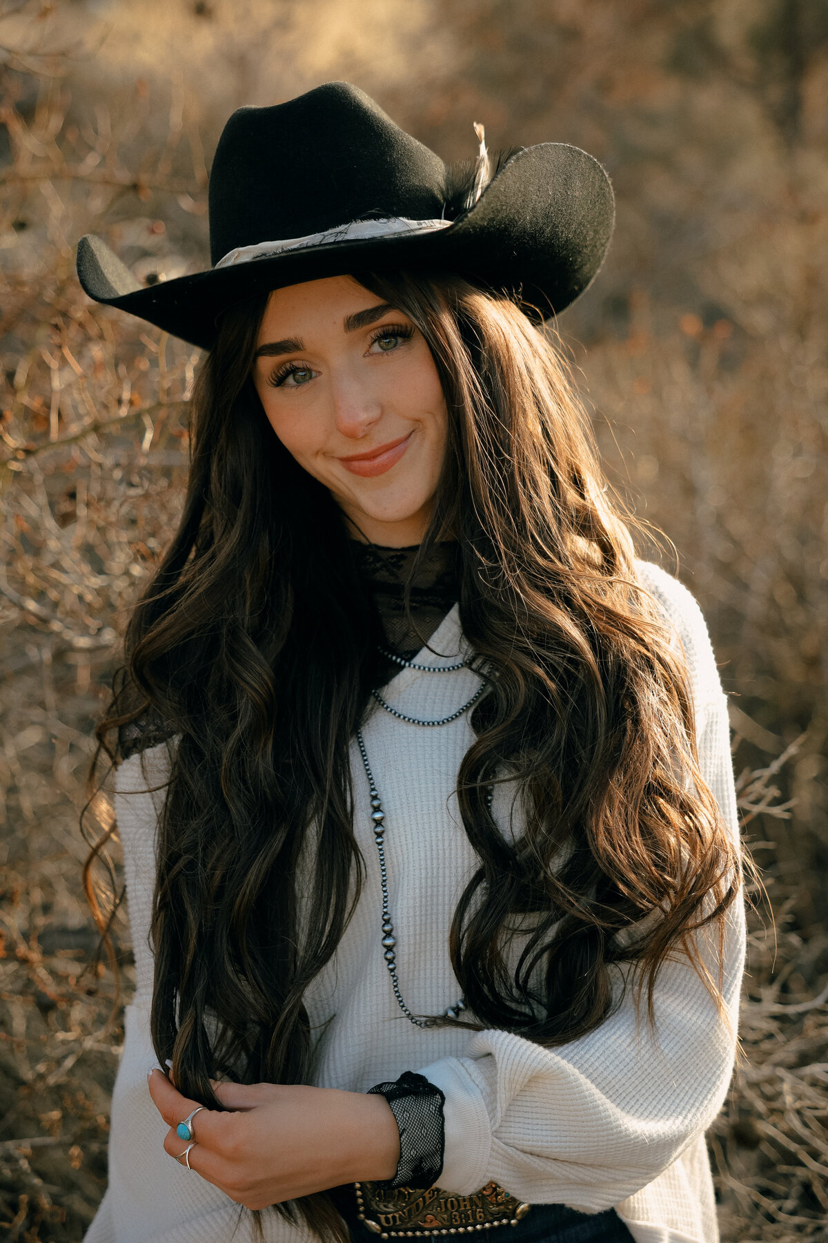 Artistic Editorial Senior Portrait of Girl Walking in Desert Field Wearing White Dress