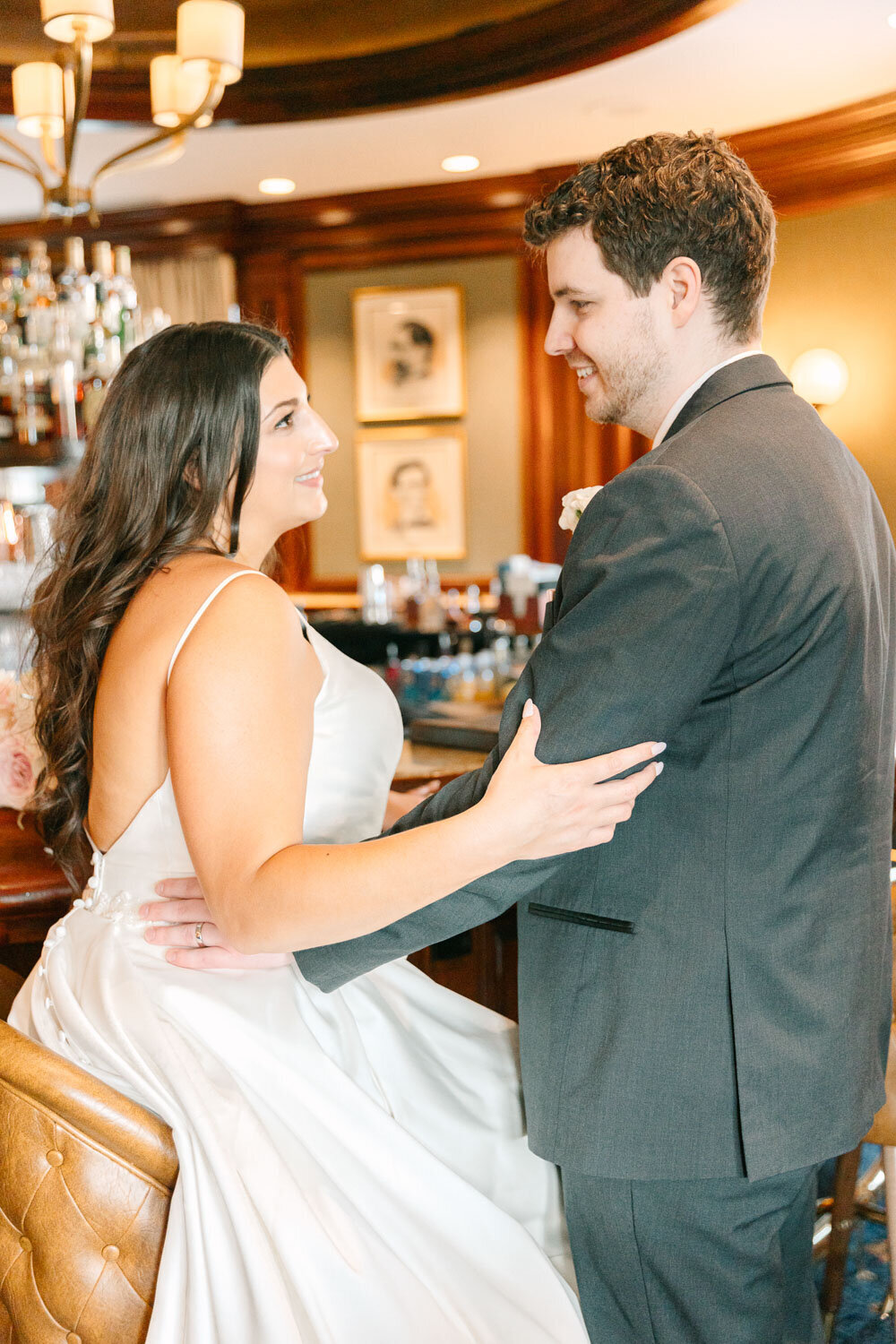 Bride and groom share a moment at the bar