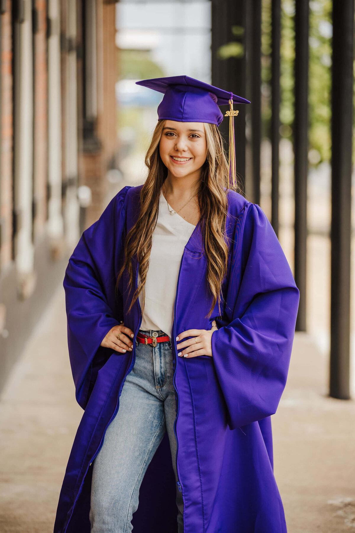 senior portrait of Hallsville I.S.D. graduate in purple cap and gown