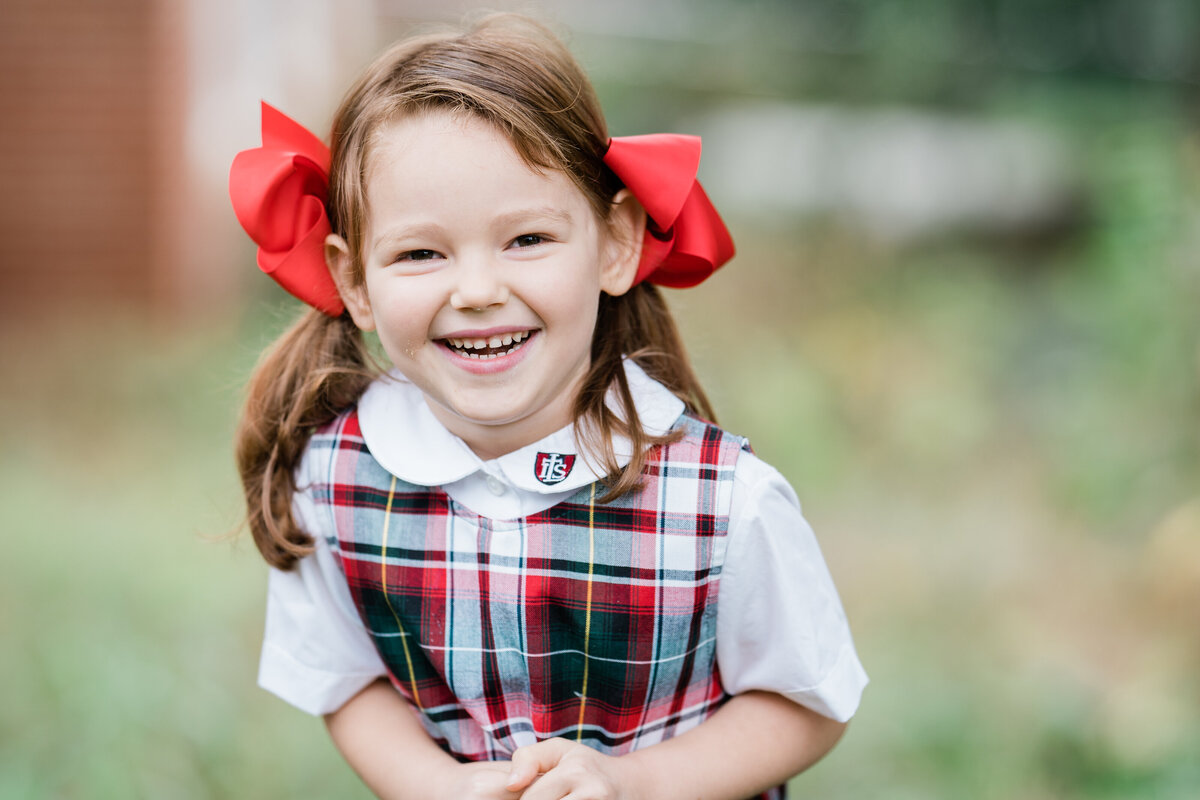 happy-girl-in-uniform-with-red-bows
