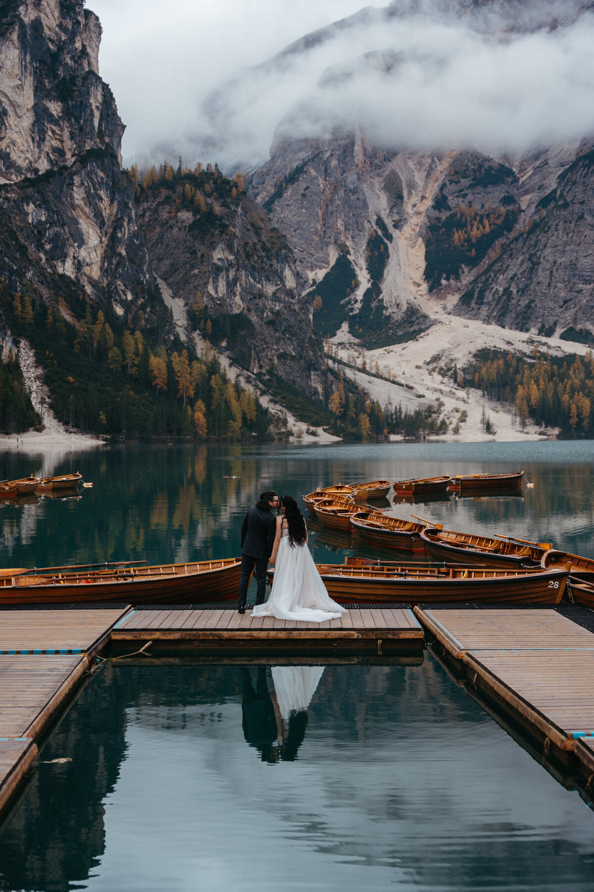 Lago di Braies sunrise elopement couple on La Palifitta dock