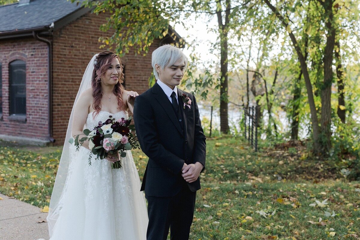 Groom about to see her bride in a wedding dress for the first time