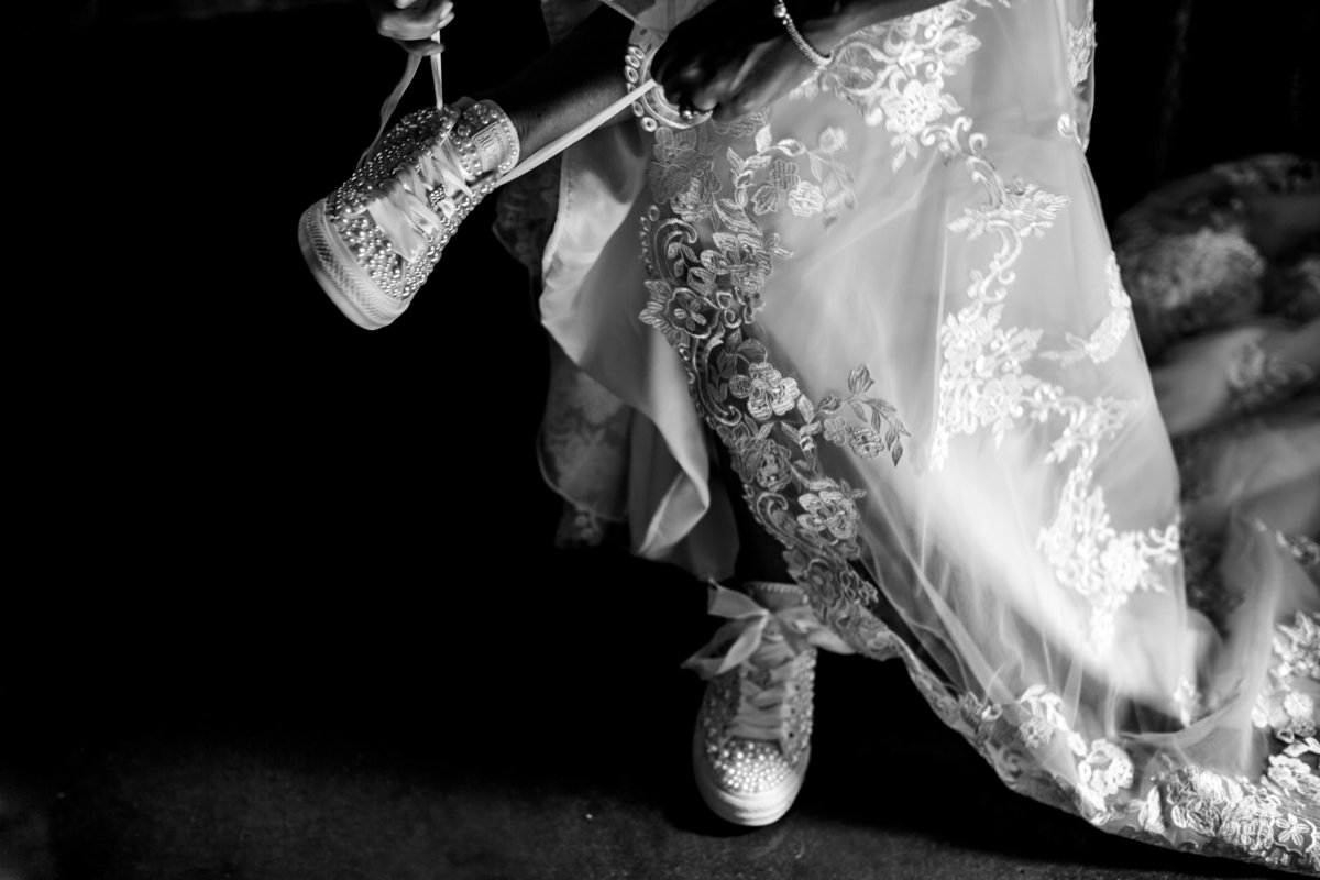 Bride ties her wedding shoes on wedding day at The Chandelier of Gruene