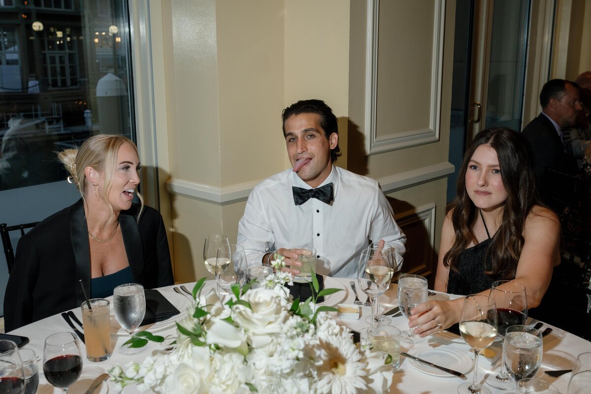 wedding-guest-groomsmen-sticking-tongue-out-at-photographer