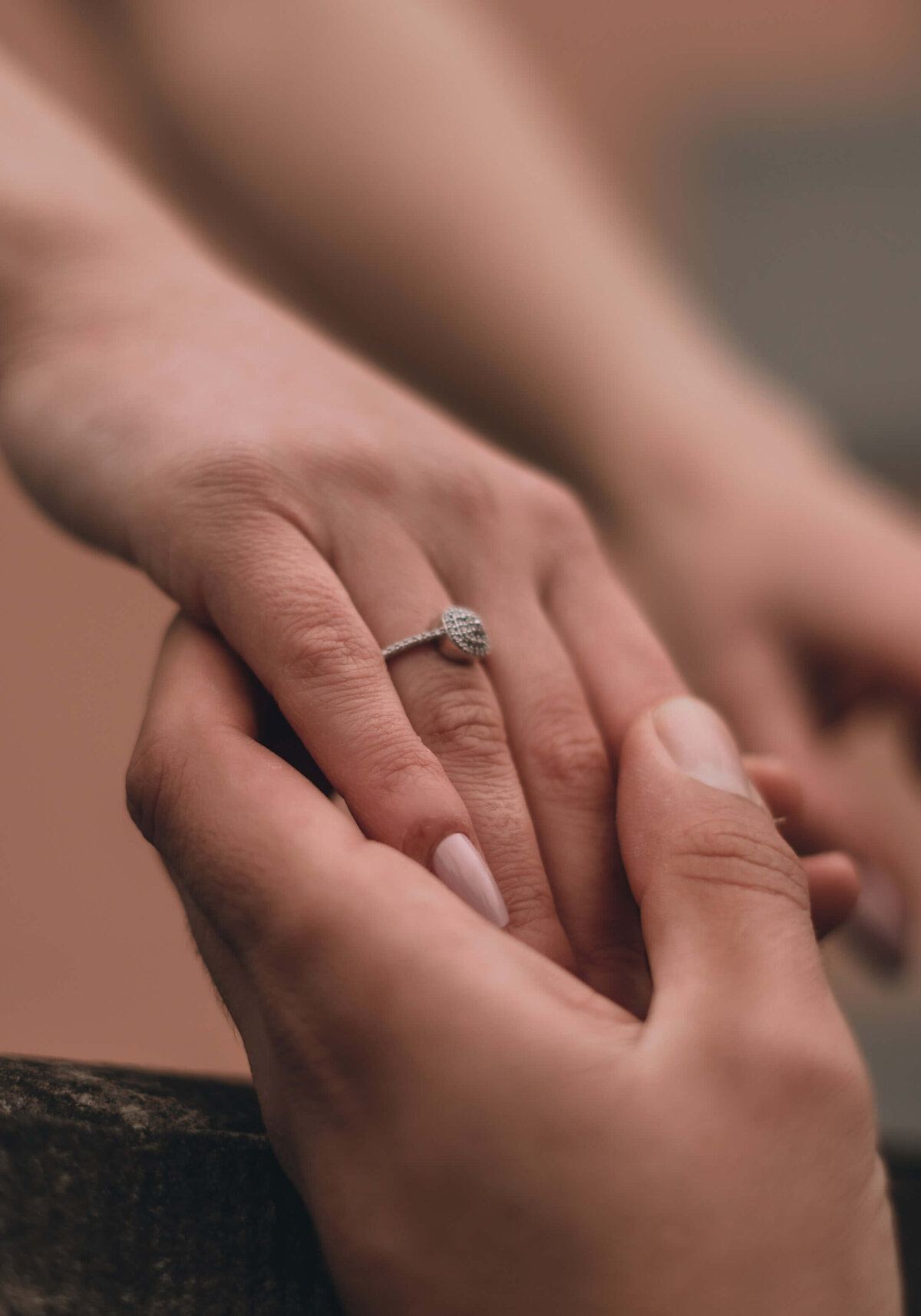 Man Holding Woman Hand with Engagement Ring
