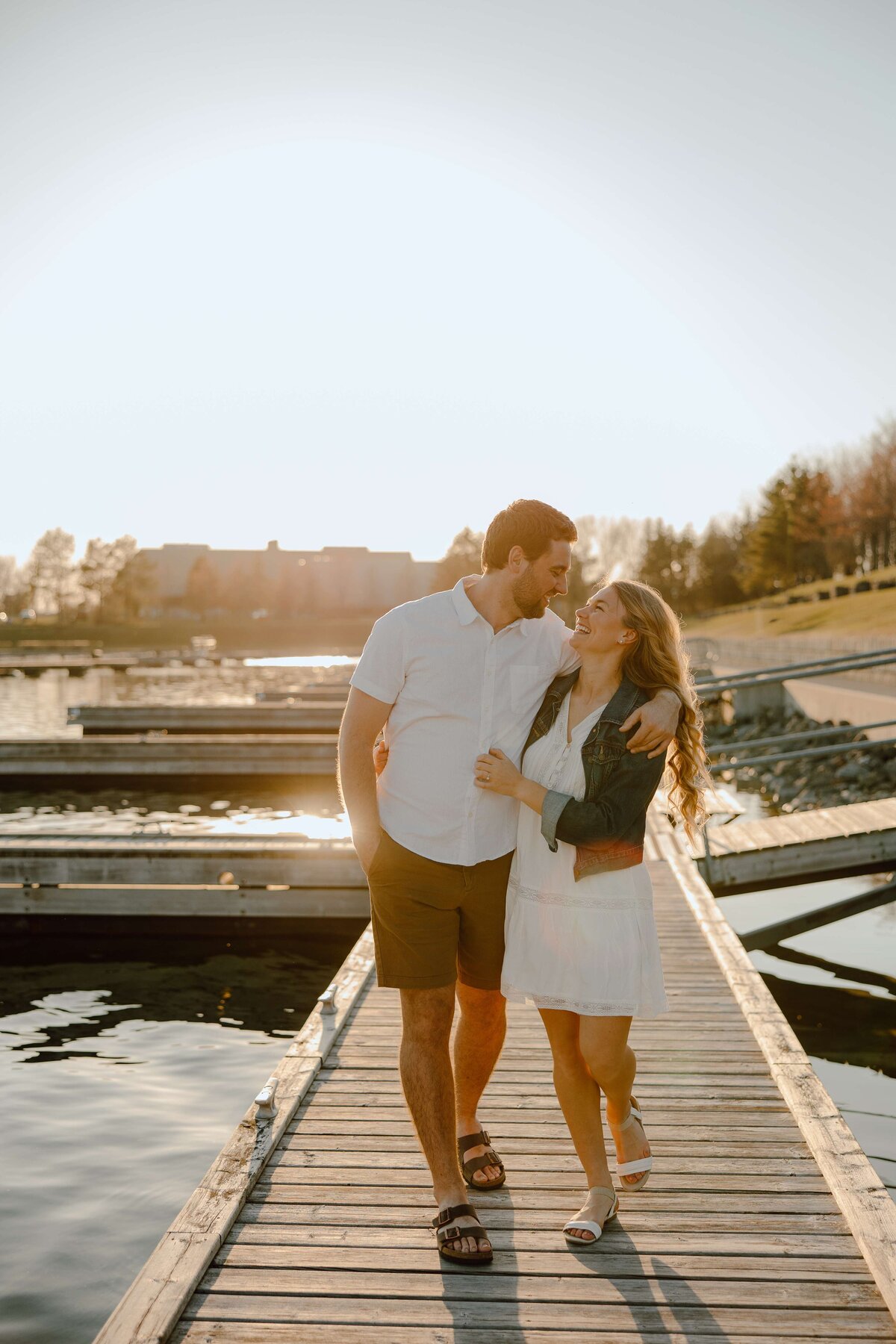 couple smiling at each other on a boardwalk