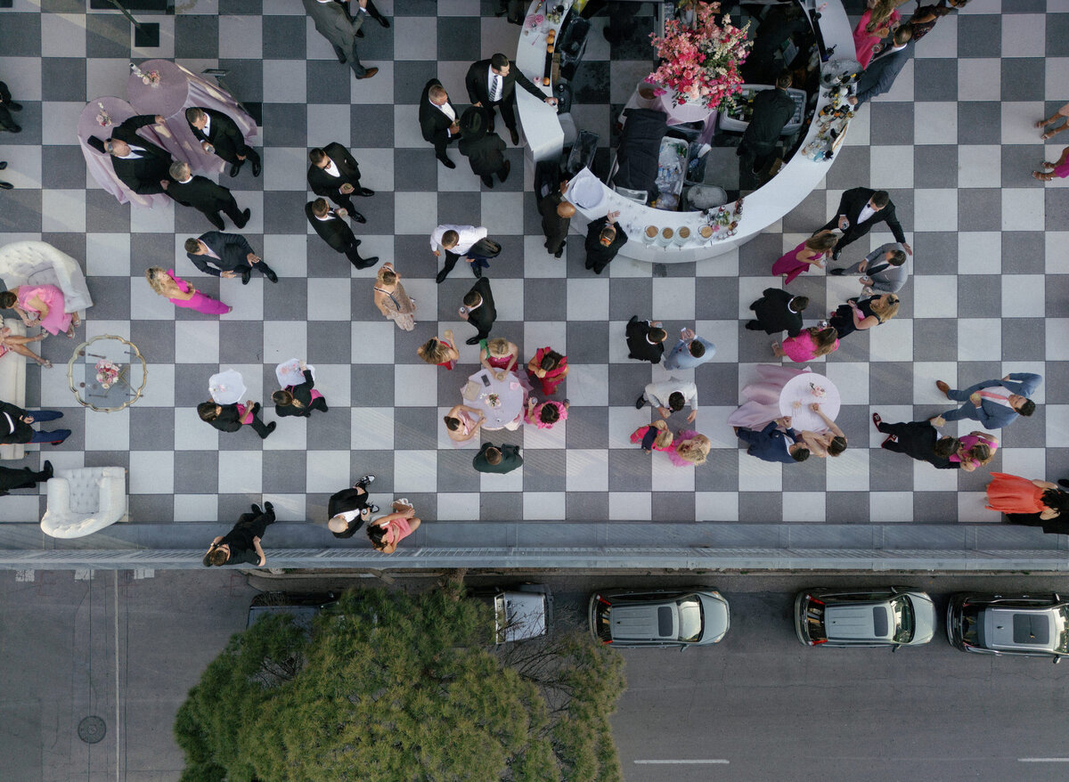 checkered floor of party on large rooftop patio  from above
