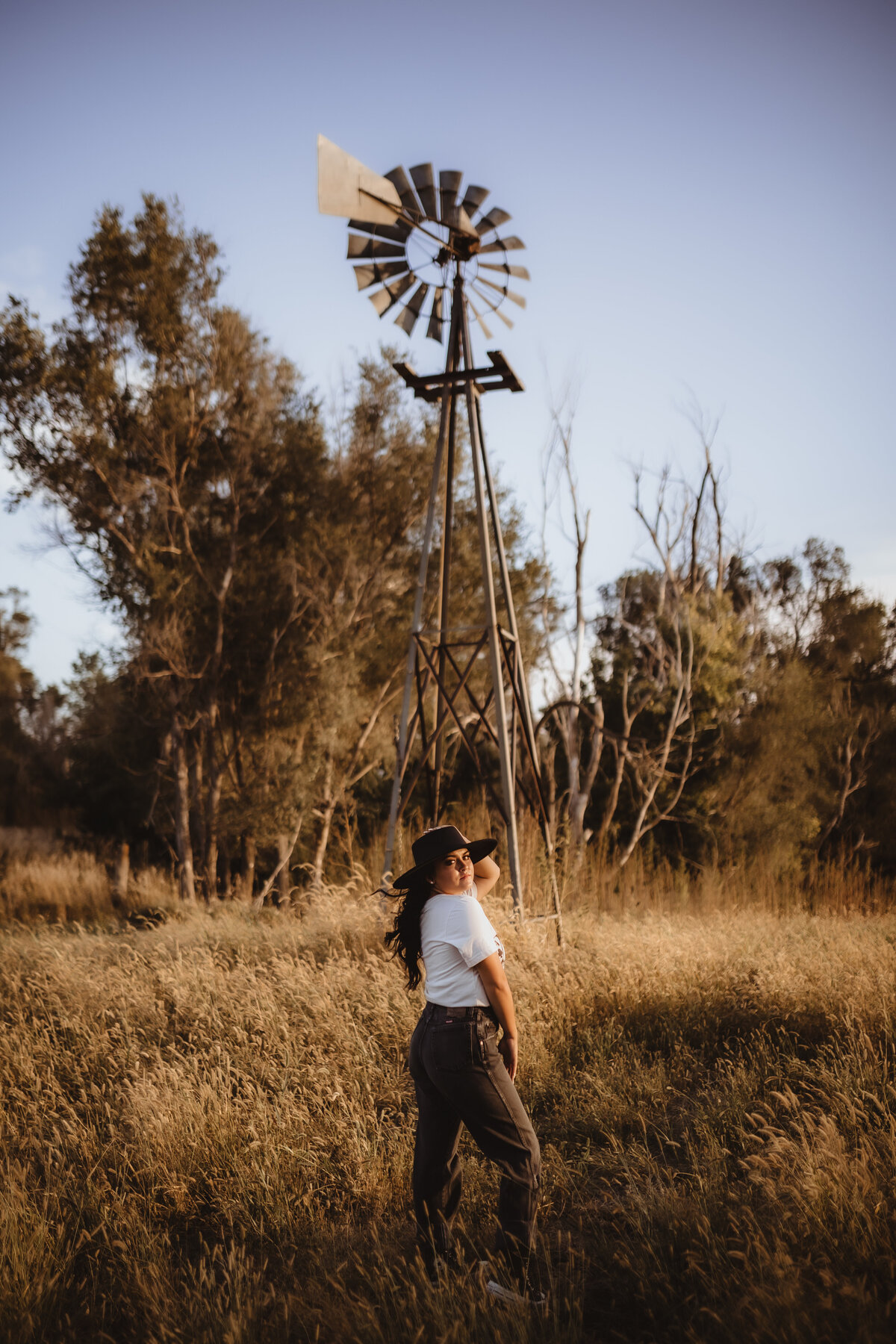 SENIOR BY WINDMILL IN WIND