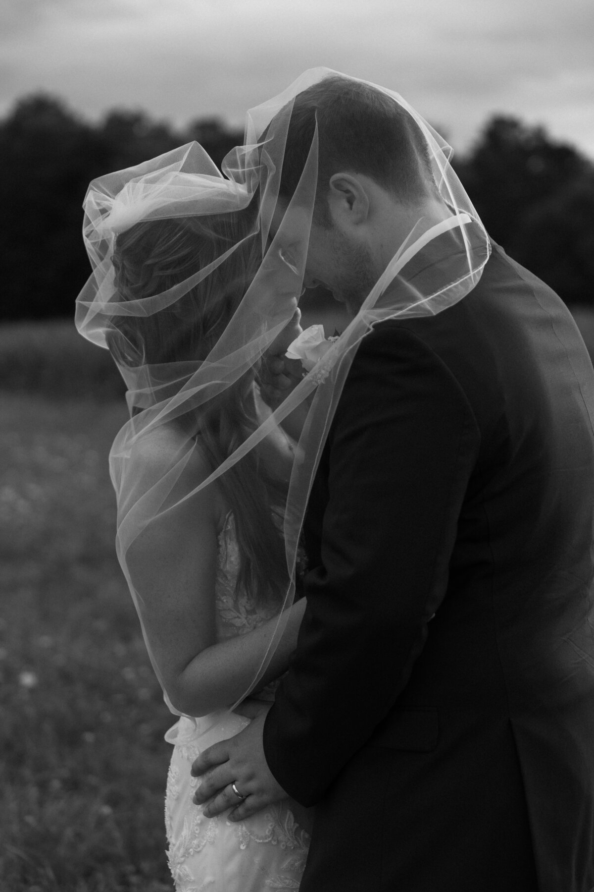 bride-and-groom-under-veil-intimate-moment