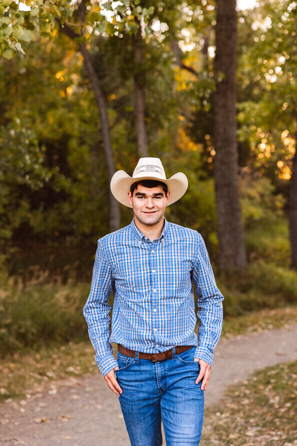 Senior boy poses with hands in pockets at Fly N B park in Highlands Ranch, CO.