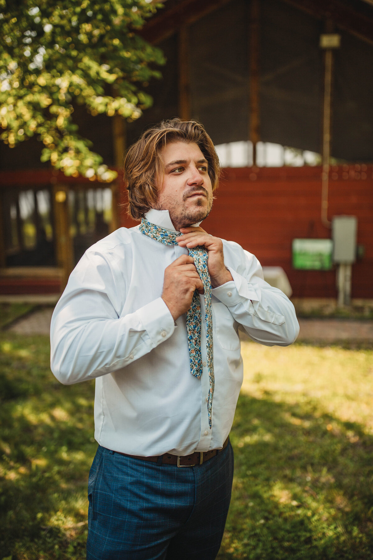 groom putting on tie