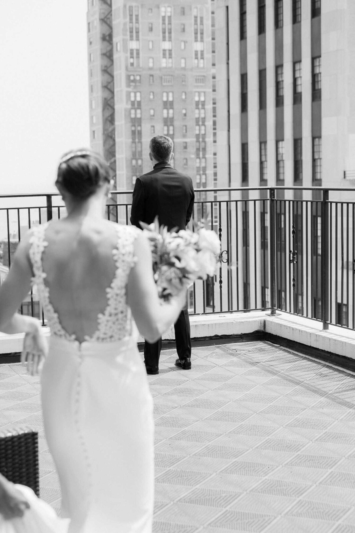 Bride walking out for first look on the rooftop of the Ambassador Hotel in Downtown Chicago before her Luxury Chicago Outdoor Historic Wedding Venue .