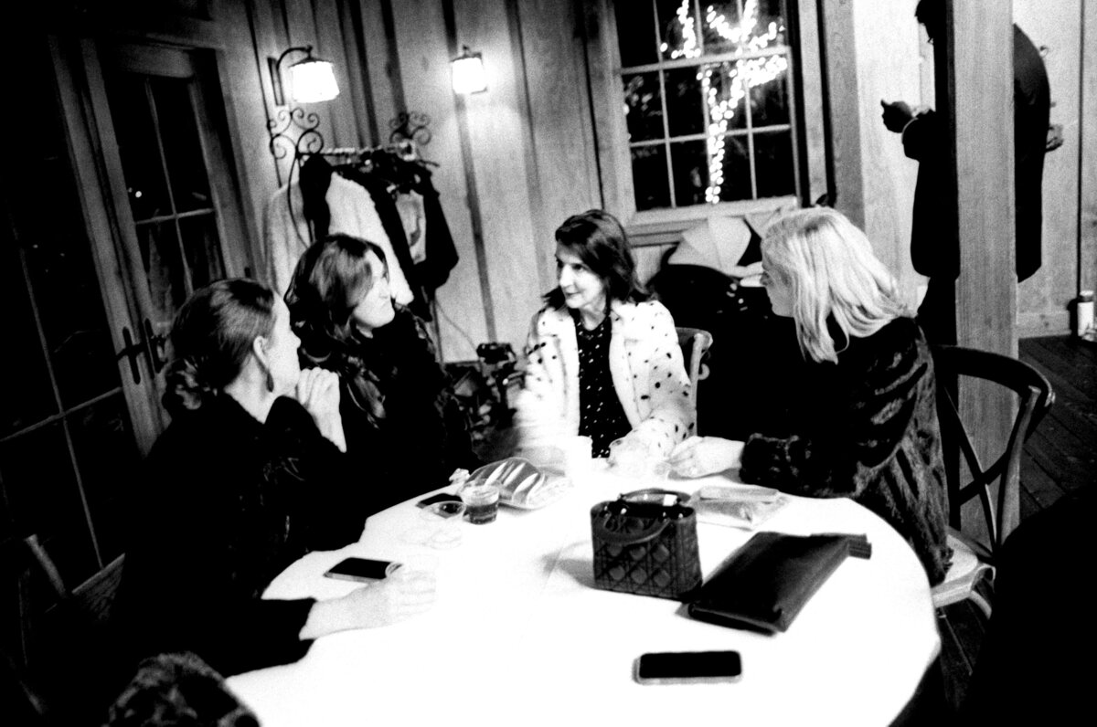 Timeless black and white photo of a group of mothers chatting during a wedding, captured in a documentary wedding photography style — Carmel wedding photography by Kate Winters Photography.
