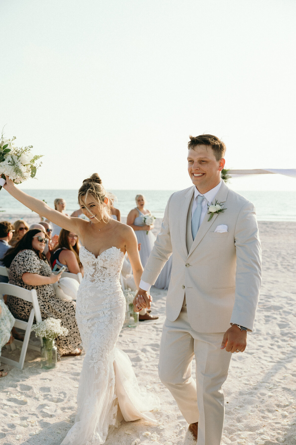 Bride and groom celebrating with friends, photographed by Ryann B Photography, specializing in Indiana weddings.