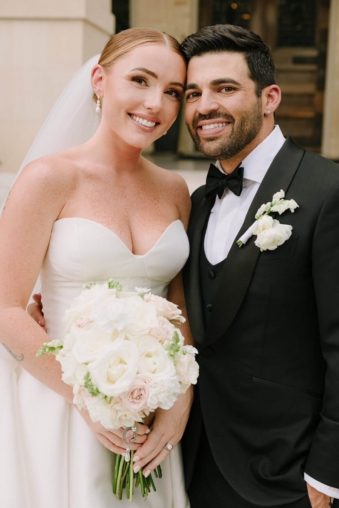 This bride’s flawless makeup and sleek bridal bun highlight her natural glow. Featuring a soft glam look by our San Antonio wedding hair and makeup team, her fresh French nails complete the polished style. Ask about our nail salon services to elevate your wedding day prep.