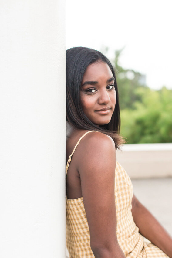 Senior girl leaning against pillar