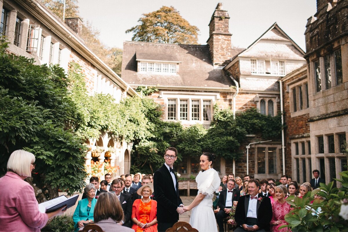 Wide view of courtyard wedding ceremony at Lewtrenchard Manor