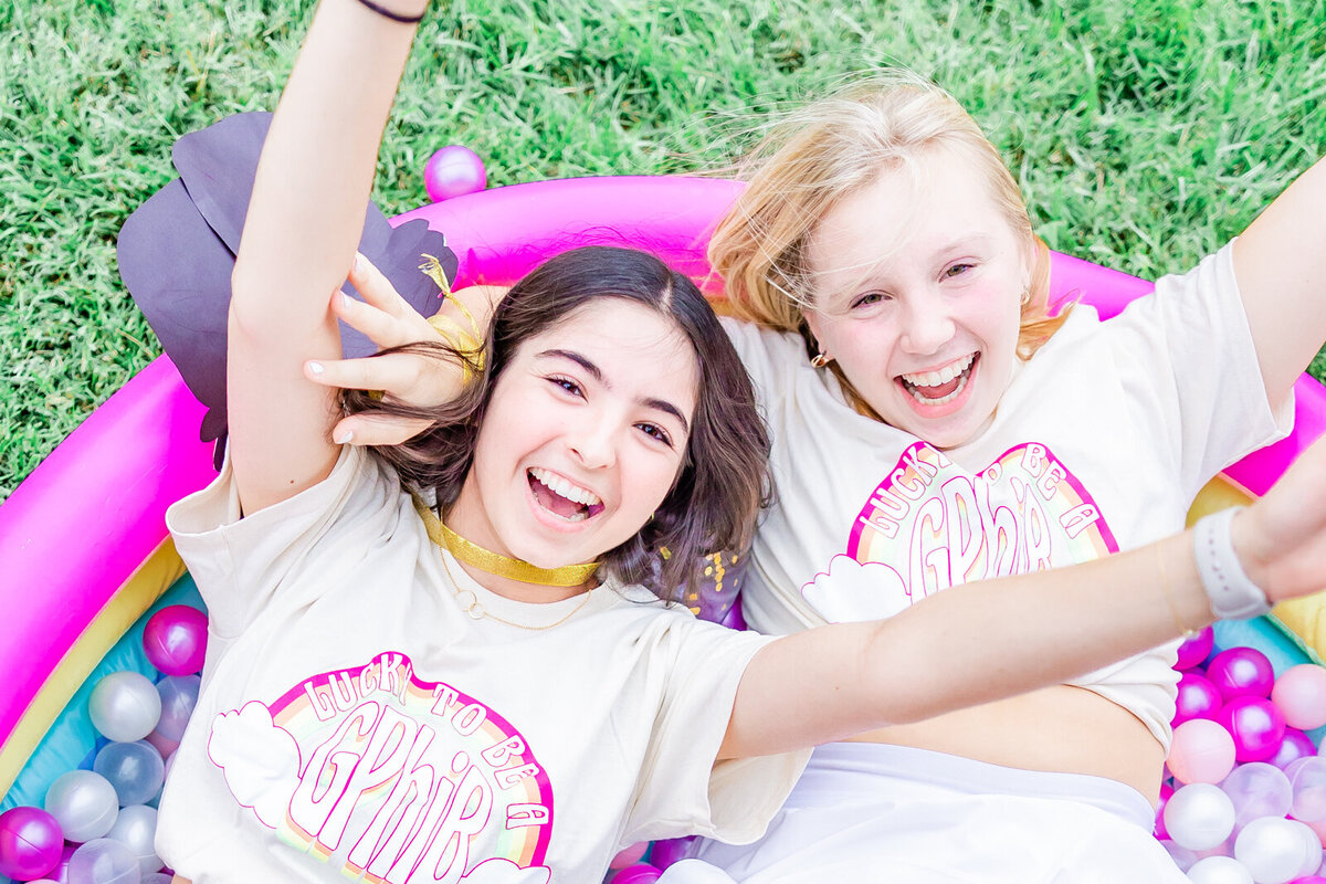 2 girls in a ball pit on bid day for Gamma Phi at SLU