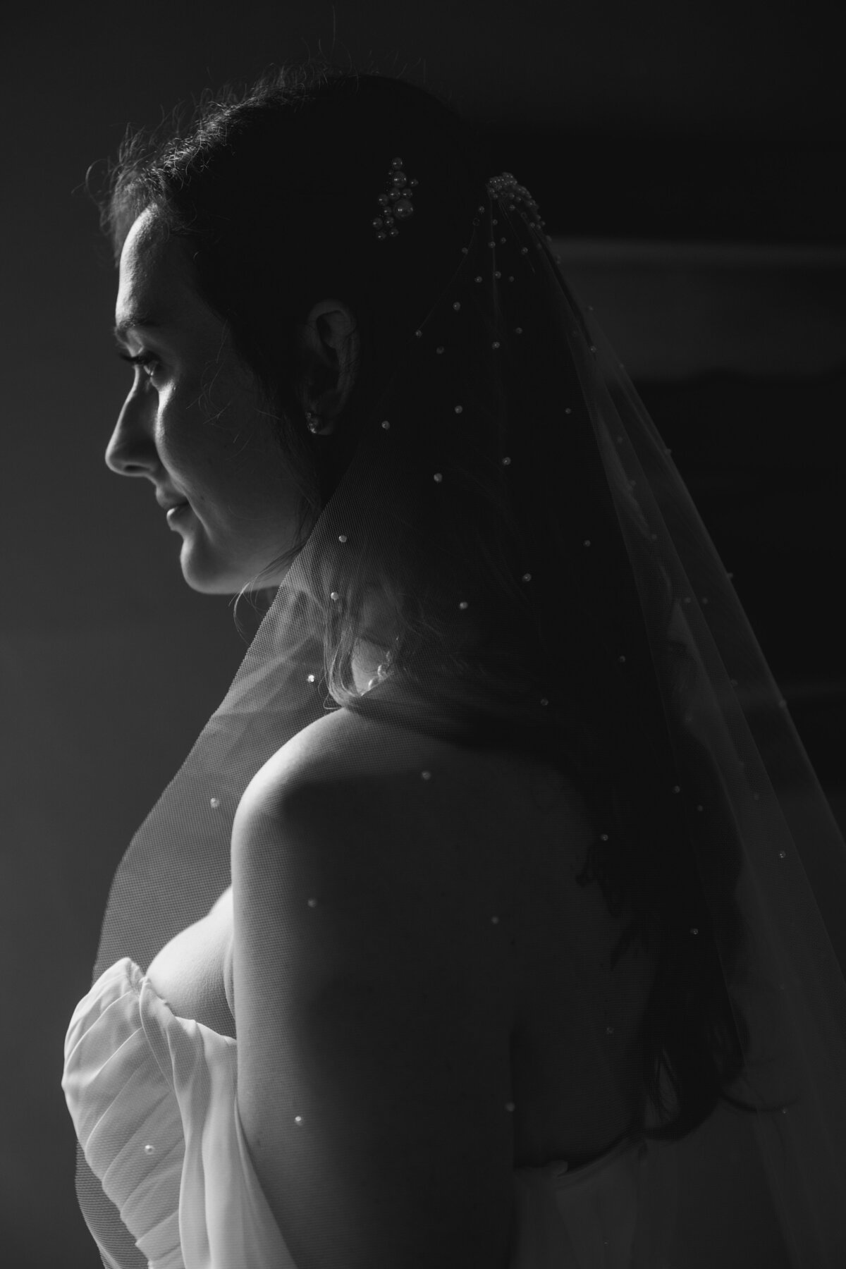 A black and white portrait of a bride on her wedding day.