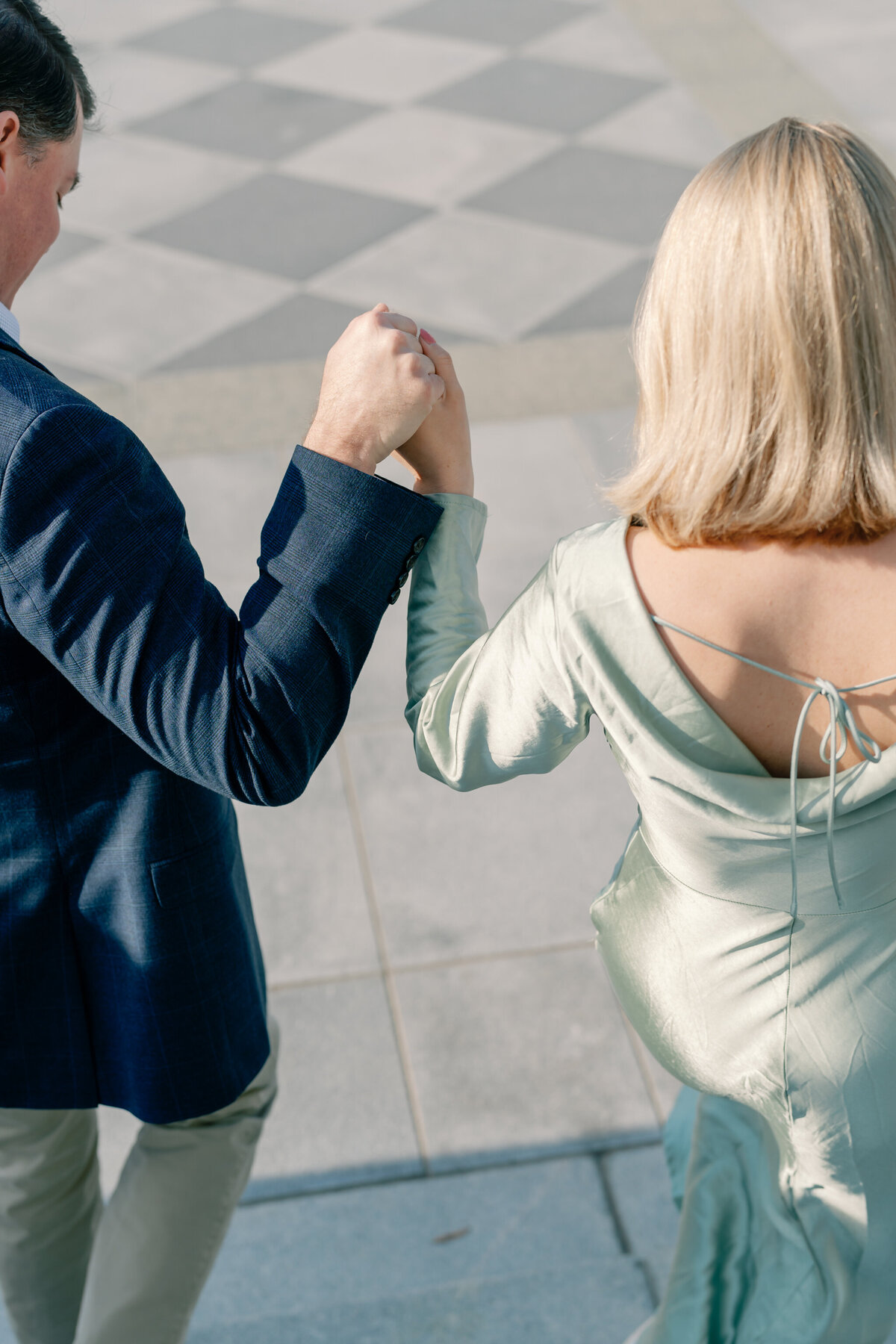 Engagement Session at the Virginia Capitol Building | Engagement Photographer in Richmond VA | closeup image of engaged couple holding hands as they walk down the stairs of the Virginia Capitol Building