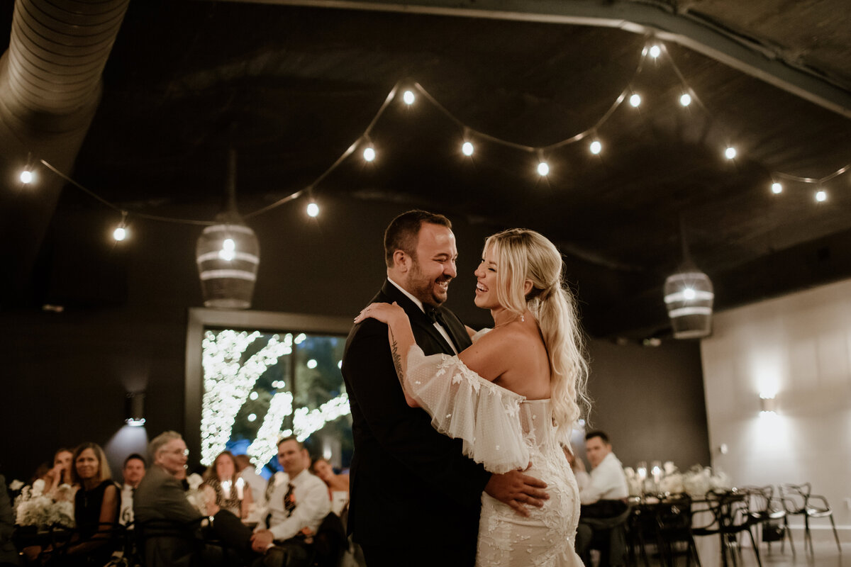 A first dance under the lights at Lazy S Hacienda in Weatherford Texas. Captured by Fort Worth Wedding Photographer, Megan Christine Studio