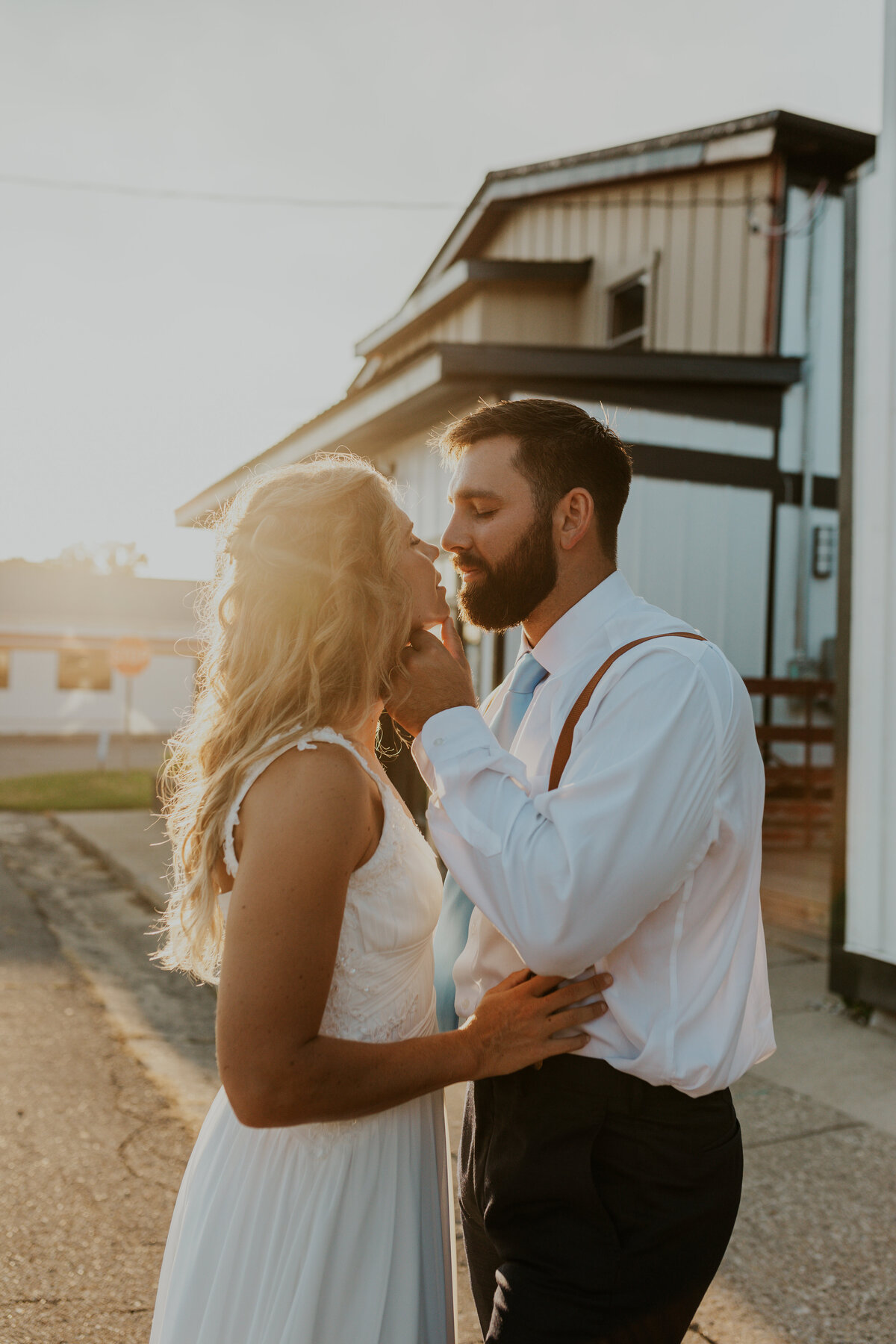 Bride and groom share a tender moment under soft lighting, Indiana wedding.
