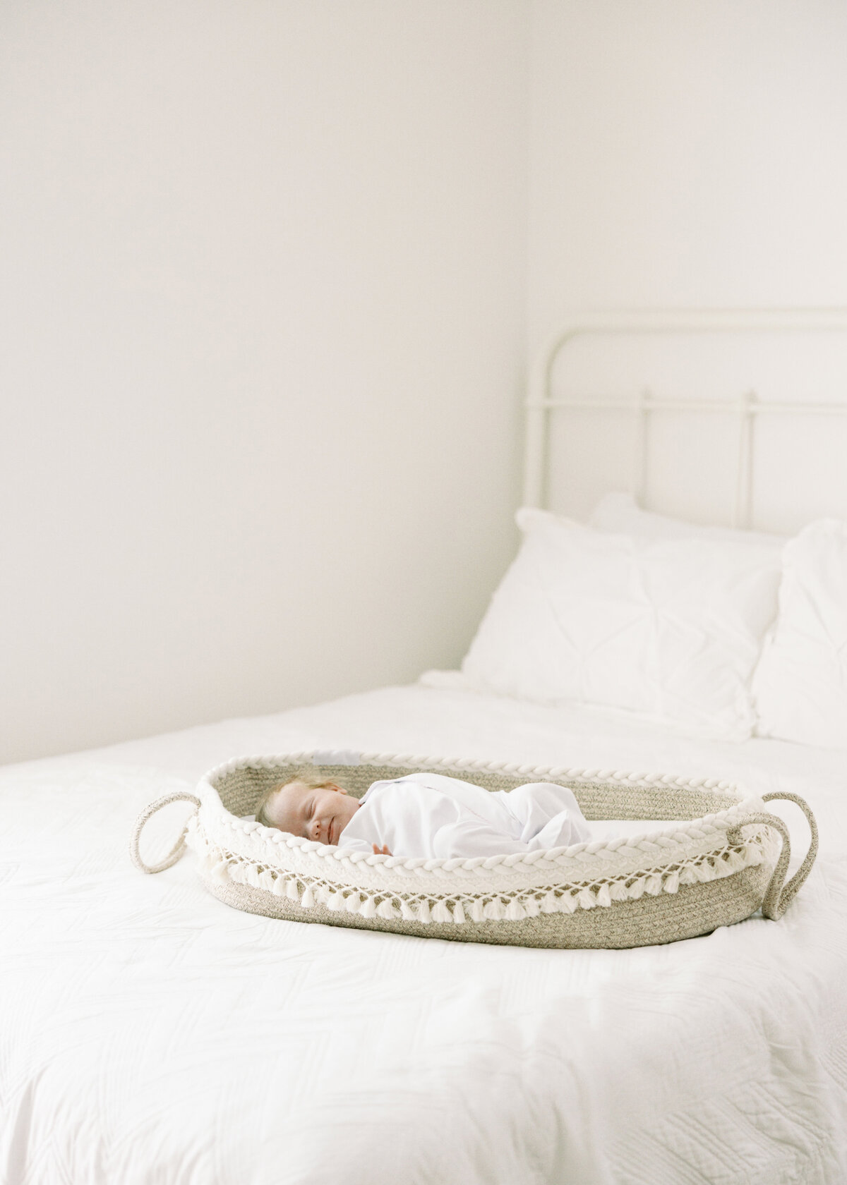 Sleeping baby in a moses basket in Williamsburg Virginia