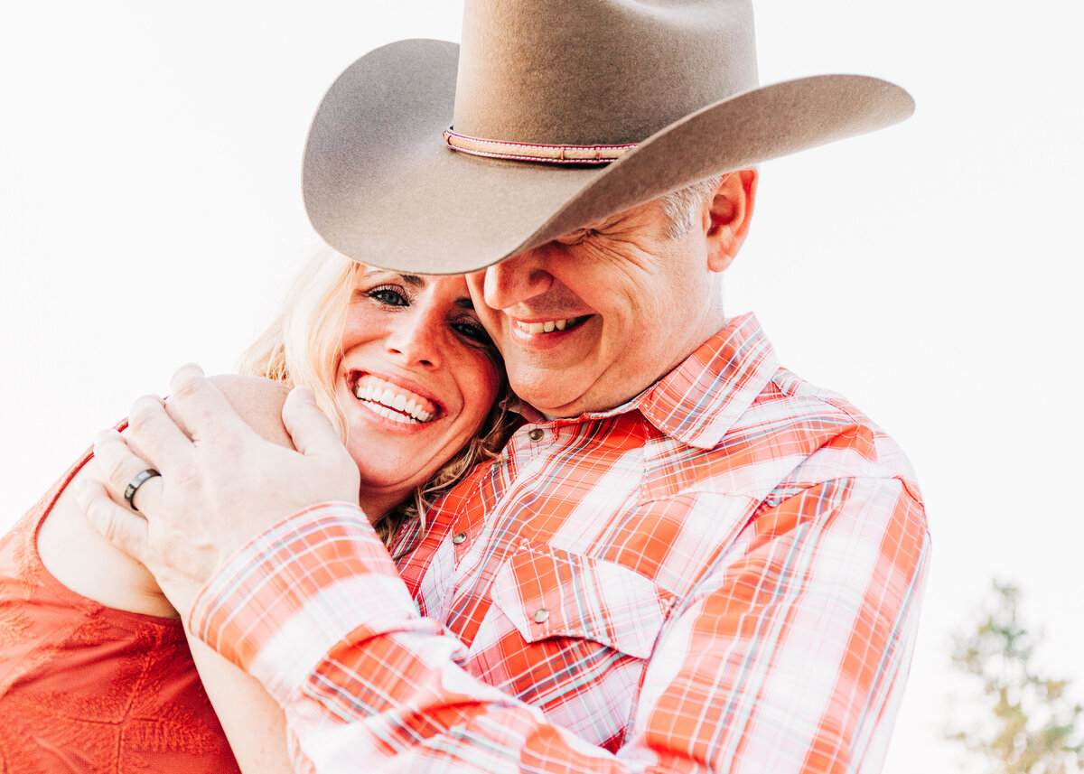 Close up photo engagement couple smiling and hugging at Travelers Rest State Park in Lolo, MT