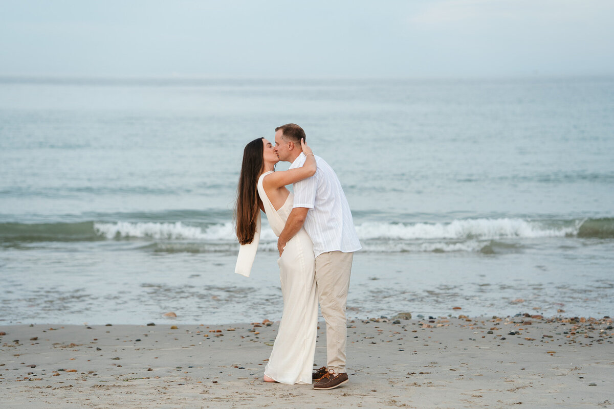 Romantic coastal engagement session in New England overlooking the shoreline.