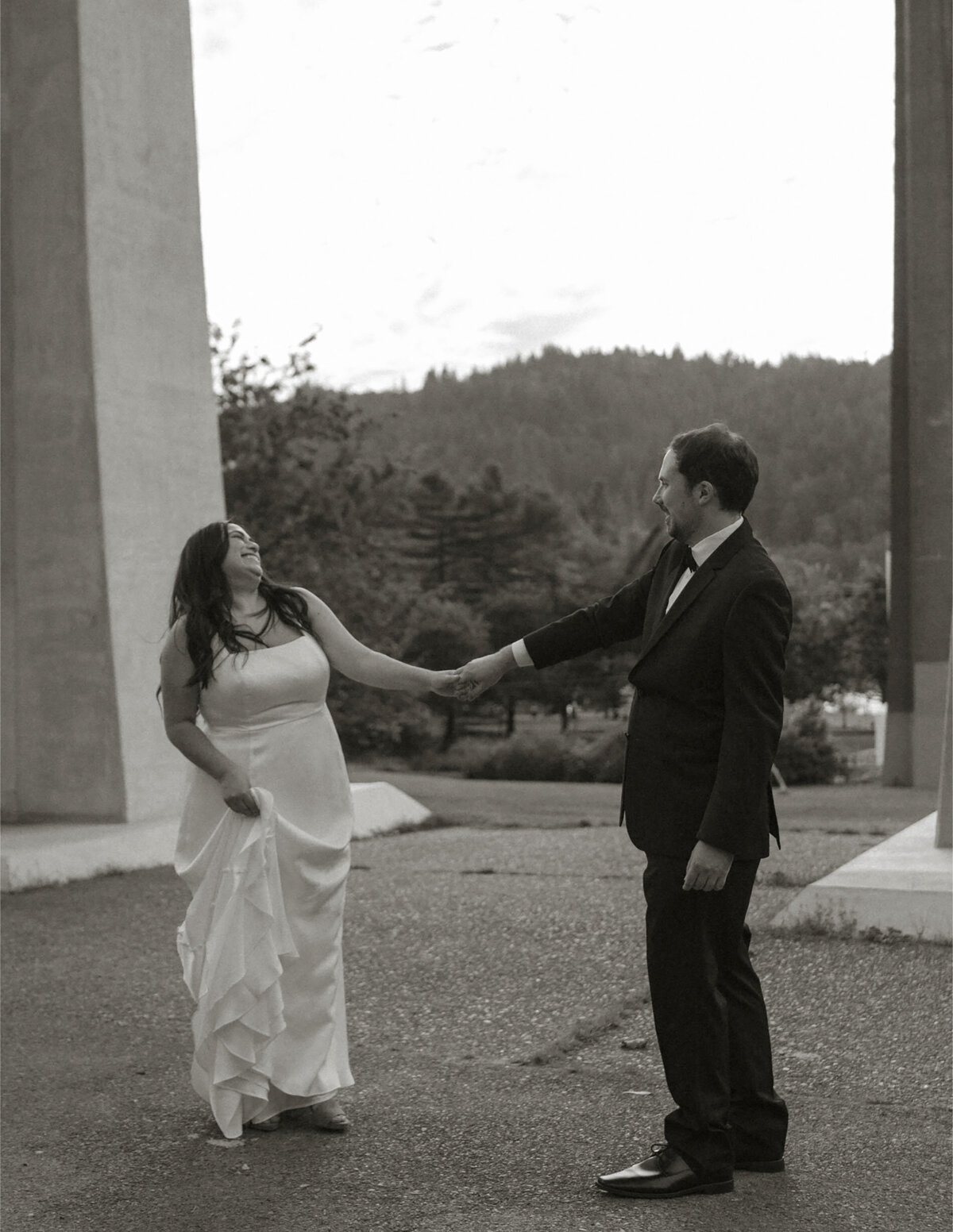 bride and groom hold hands and dance at their wedding venue after their ceremony in Bend, OR